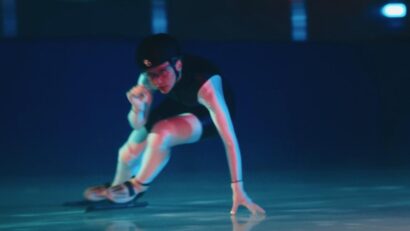 olympic ice skater in red white and blue lighting going fast for a premium pet food commercial that aired on broadast during the 2026 winter olympics